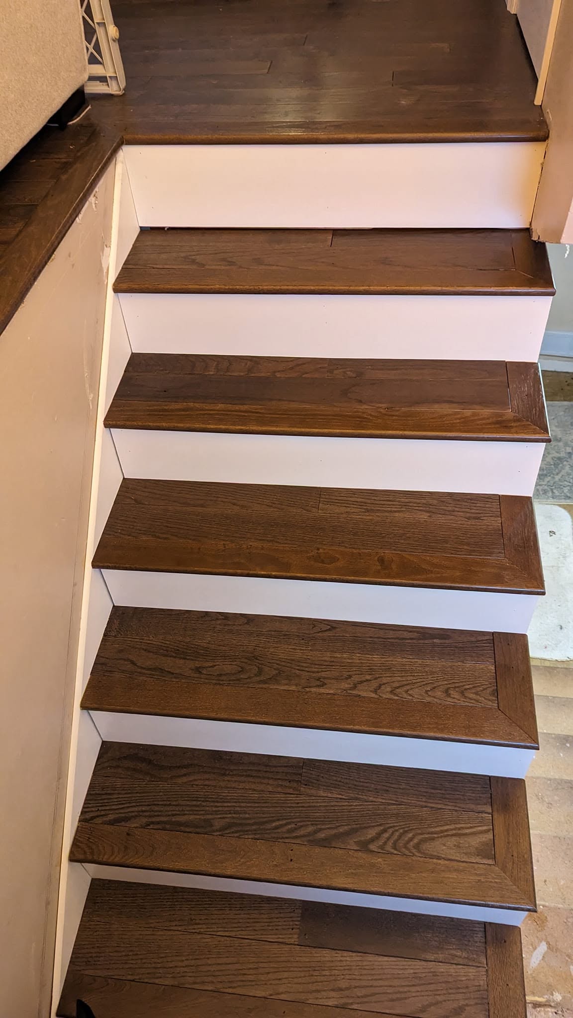 Solid wood stair treads with crisp white risers, installed and finished