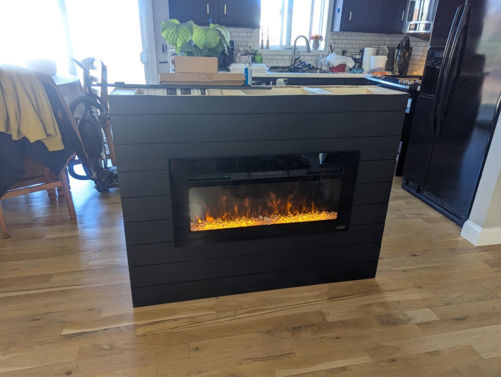 A custom charcoal fireplace wall we built and finished beside the kitchen