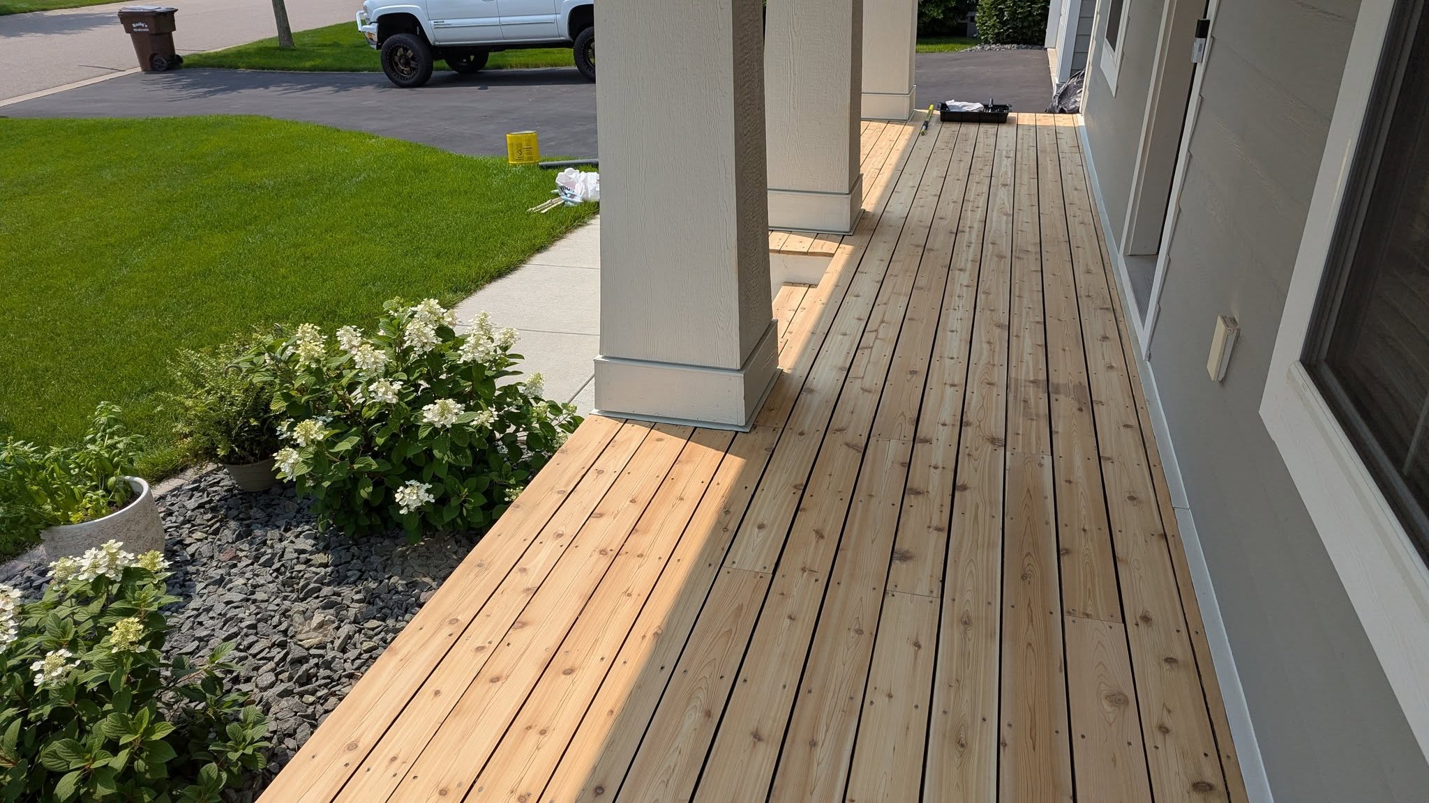 A long cedar porch floor we laid and finished, running the length of the home